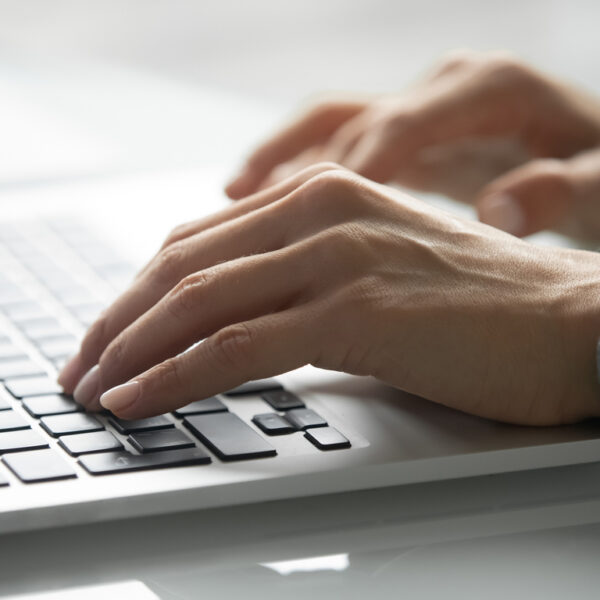 Close up of female hands typing texting on modern laptop keyboard, young woman message consult client or customer online, girl work on computer gadget write reply, new technology concept